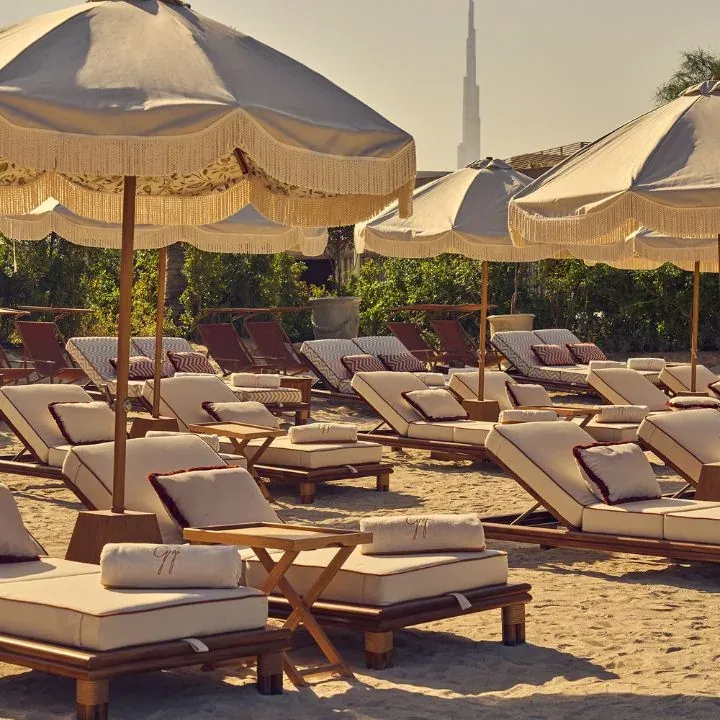 Sunbeds and fringed parasols on the sand at Gigi Rigolatto, J1 Beach