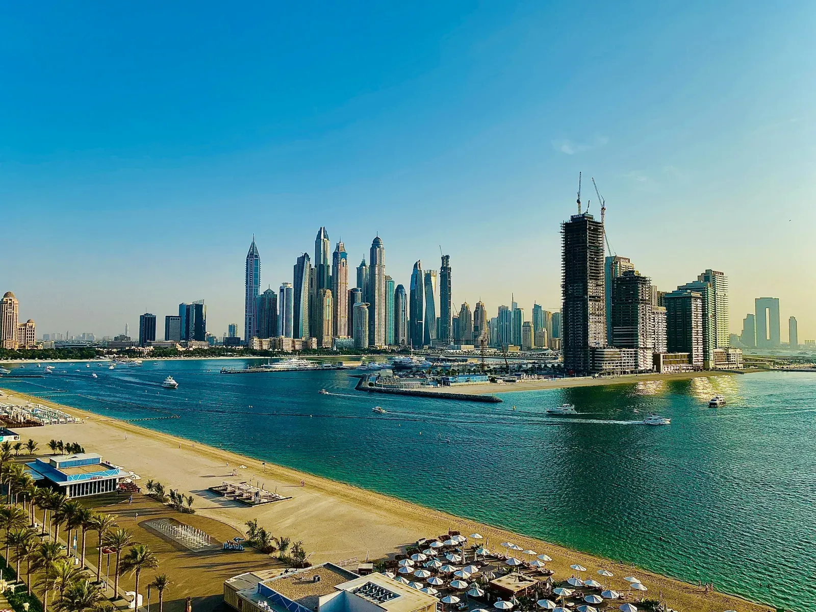 Palm West Beach and its promenade, with the Dubai Marina skyline across the water