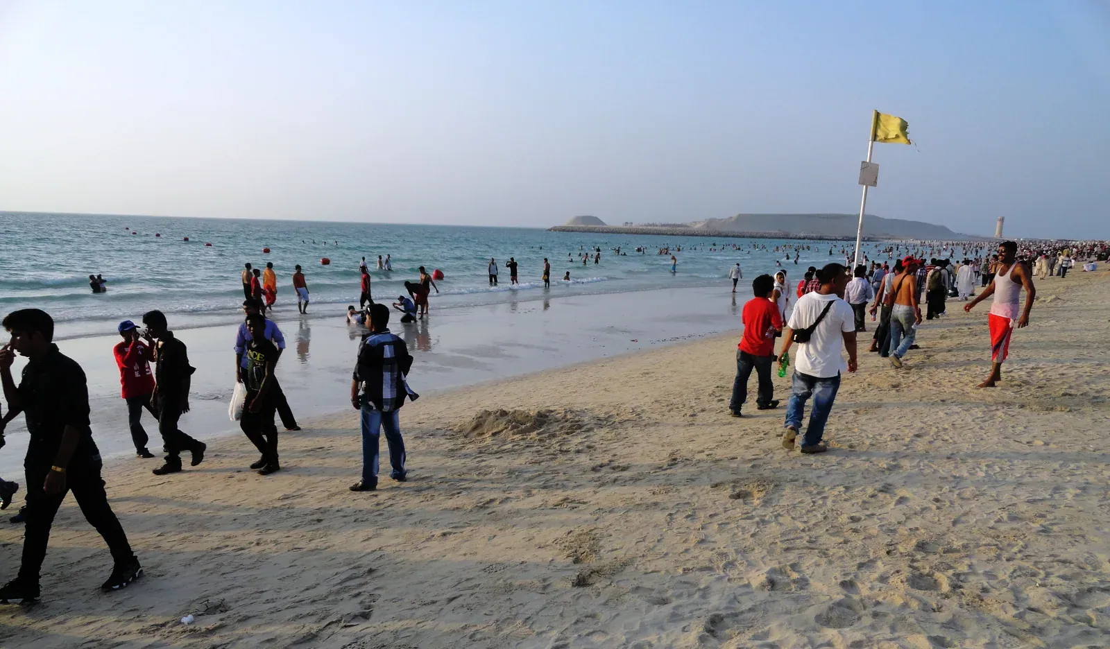 Beachgoers along Umm Suqeim Beach in an archival wide shoreline view