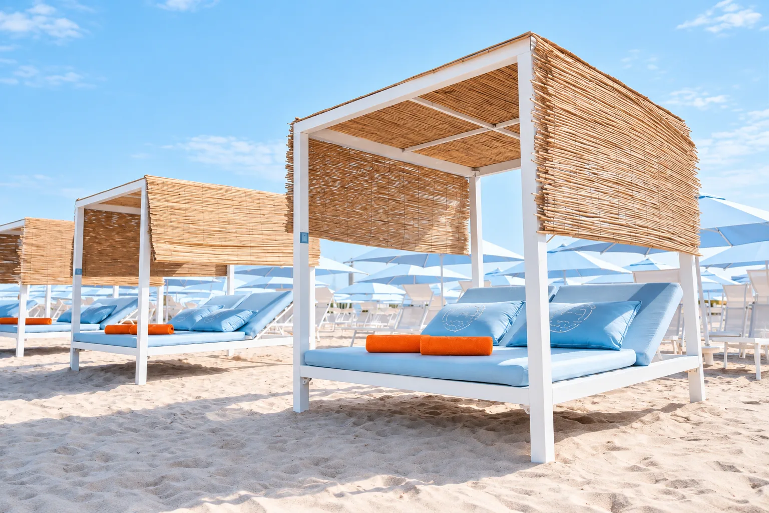 White Sole Mio cabana with cushioned seating and woven shade