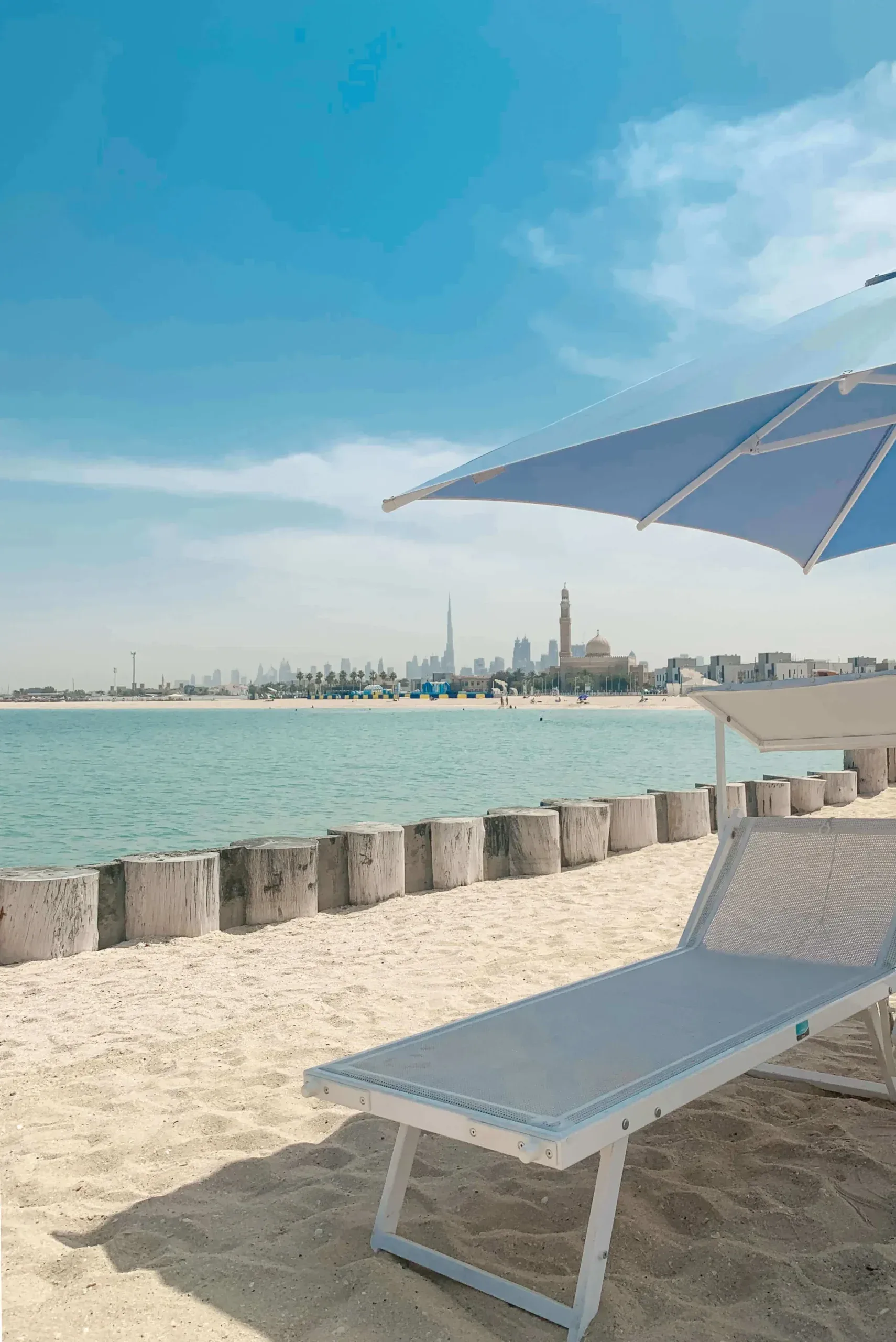 Turquoise water and the Dubai skyline seen from a sunbed at Kite Beach