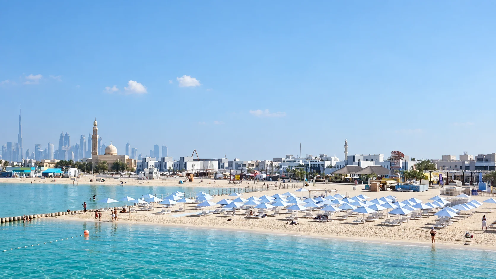 Aerial view of Sole Mio’s blue umbrellas beside the turquoise sea on Kite Beach, Dubai