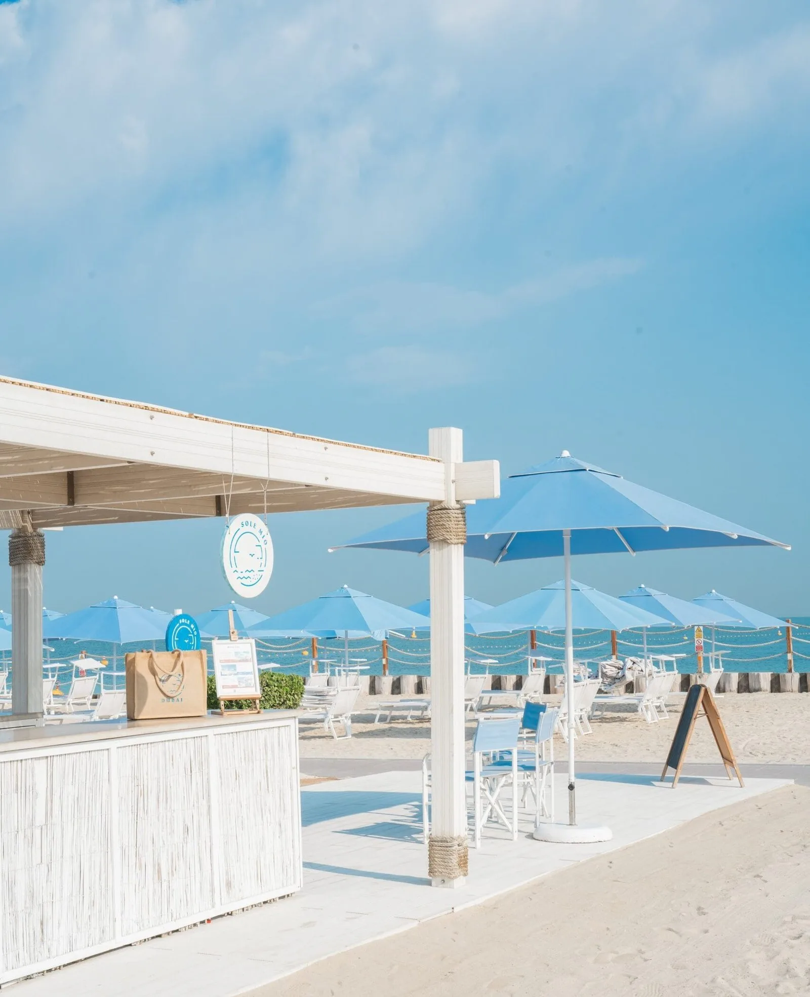 Sole Mio reception on Kite Beach, with blue umbrellas and the sea beyond